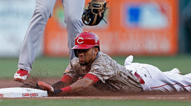 Cincinnati Reds' Billy Hamilton is safe at third with a stolen base against the St. Louis Cardinals during the first inning of a baseball game, Friday, Sept. 2, 2016, in Cincinnati. (AP Photo/Gary Landers)