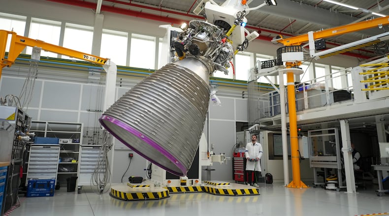 A mechanic works on the Vulcain 2.1 engine that powers the Ariane 64 rocket, at the ArianeGroup's plant in Vernon, west of Paris, Wednesday, Feb. 4, 2026. (AP Photo/Thibault Camus)