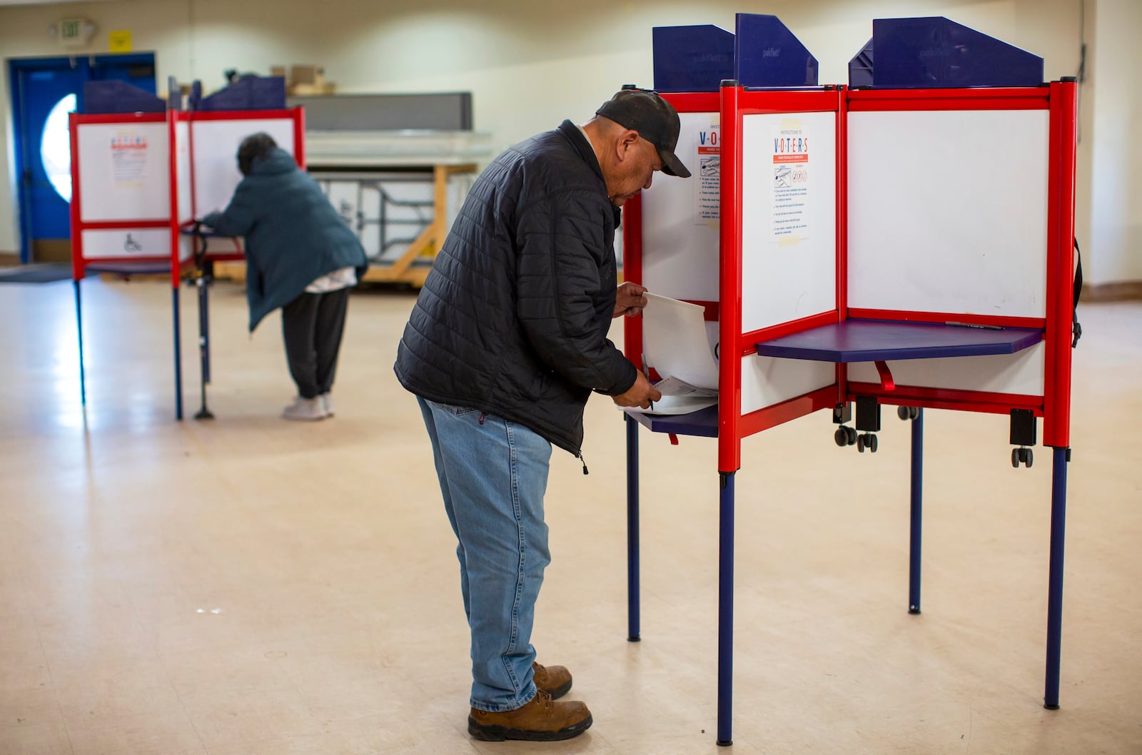 FILE - Voters mark their ballots at a polling station on the Navajo Nation in Fort Defiance, Ariz., on Election Day, Nov. 5, 2024. (AP Photo/Andres Leighton, File)