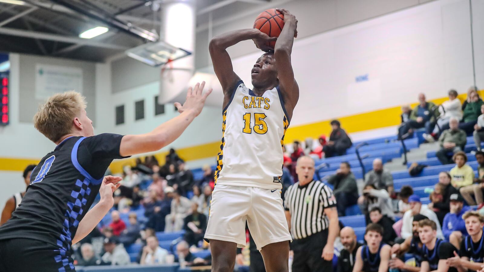 Springfield High School senior Novinsky Francois (15) shoots over a Springboro junior Brady Gutman during their game on Tuesday night in Springfield. The Wildcats won 67-55. Michael Cooper/CONTRIBUTED