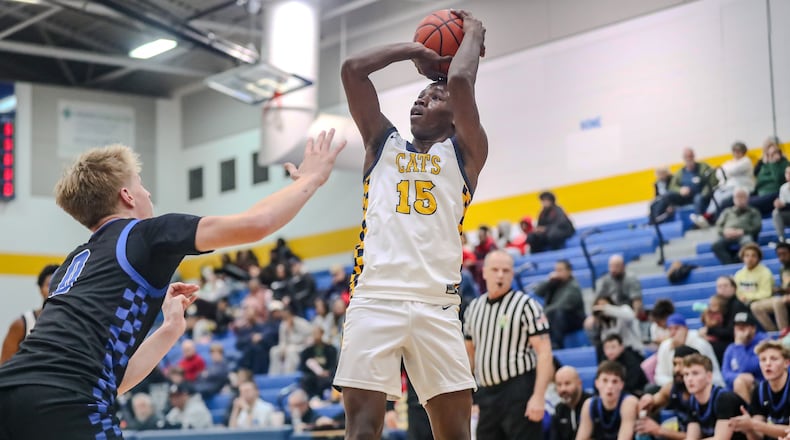Springfield High School senior Novinsky Francois (15) shoots over a Springboro junior Brady Gutman during their game on Tuesday night in Springfield. The Wildcats won 67-55. Michael Cooper/CONTRIBUTED