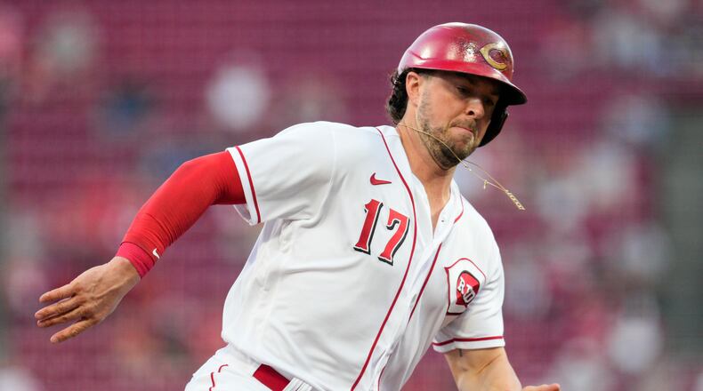 Cincinnati Reds' Kyle Farmer (17) rounds third base and scores on an Alejo Lopez single during the first inning of a baseball game against the Milwaukee Brewers, Saturday, Sept. 24, 2022, in Cincinnati. (AP Photo/Jeff Dean)