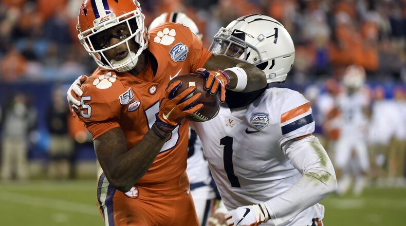 FILE - In this Dec. 7, 2019, file photo, Clemson wide receiver Tee Higgins (5) catches a pass while Virginia cornerback Nick Grant (1) defends during the second half of the Atlantic Coast Conference championship NCAA college football game in Charlotte, N.C. The NFL’s shutdown because of the coronavirus pandemic is denying teams the opportunity to get face time with draft prospects who have been injured, have checkered pasts or are under the radar. Higgins’ 6-foot-4 frame and superb hands stand out in a deep pool of receivers. Speed is the question, and a private workout might have helped. (AP Photo/Mike McCarn, File)