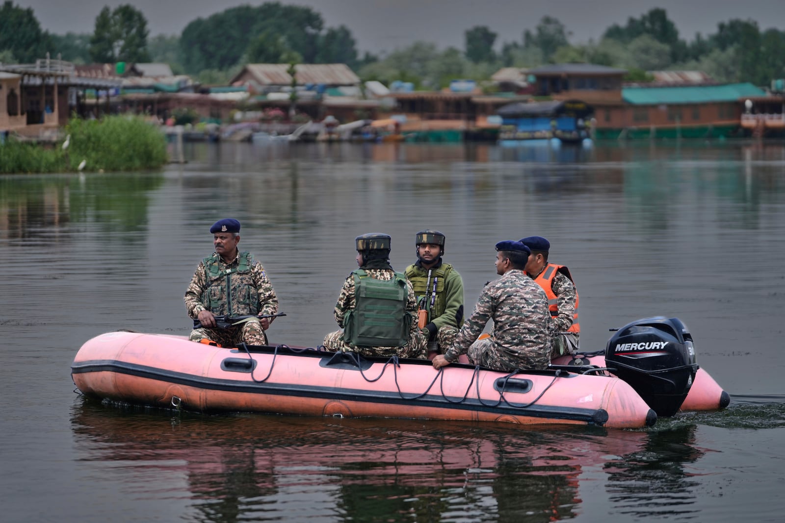 Paramilitary soldiers patrol on an inflatable boat on Dal Lake after loud explosions were heard in Srinagar, Indian controlled Kashmir, Saturday, May 10, 2025.(AP Photo/Mukhtar Khan)