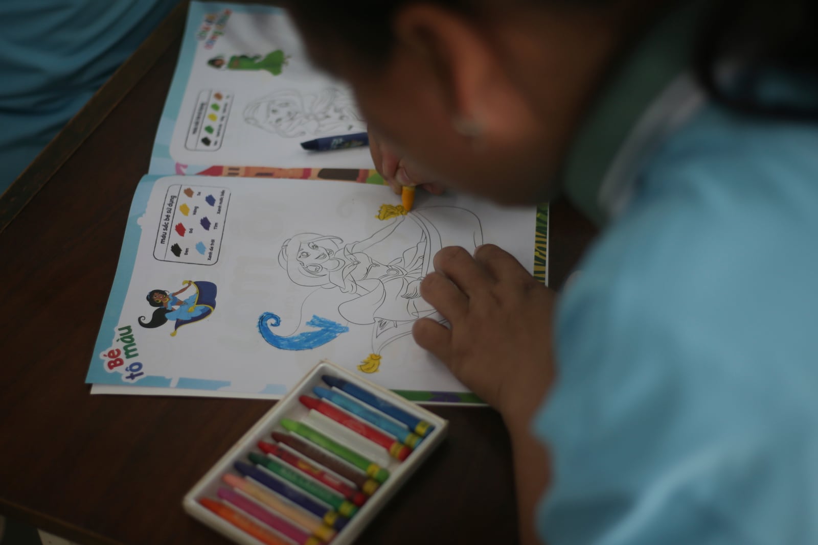 A student fills a colouring book at a school for victims of Agent Orange in Da Nang, Vietnam, March 7, 2025. (AP Photo/Aniruddha Ghosal)