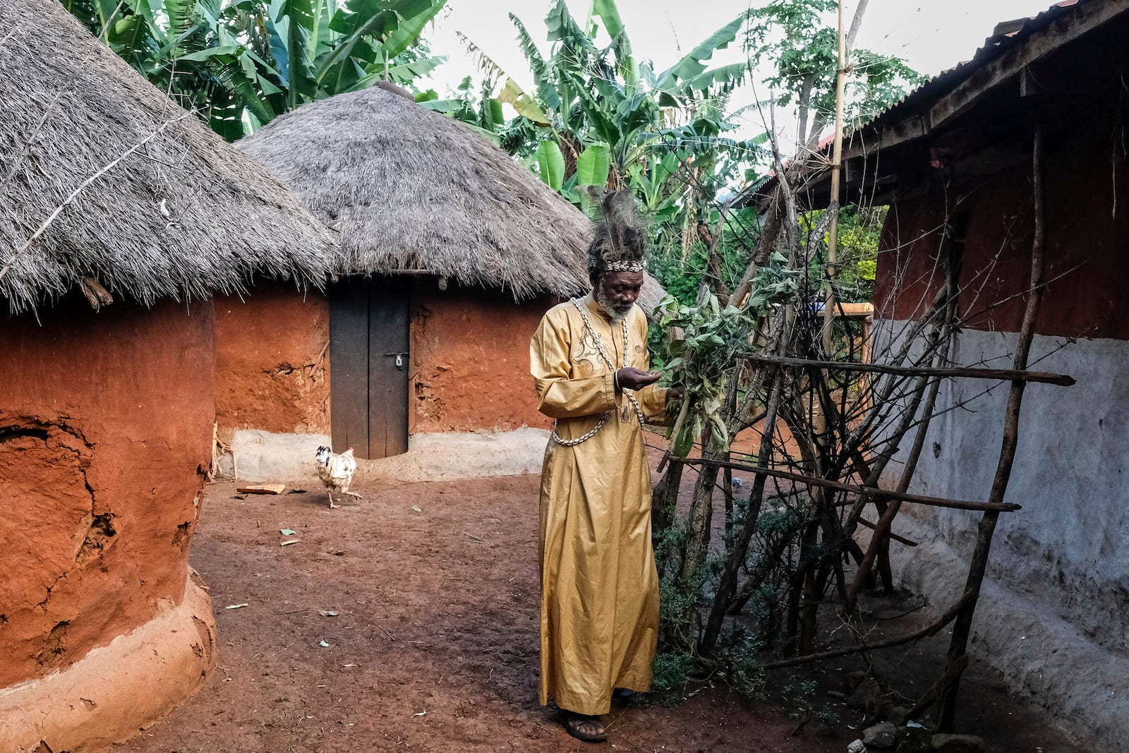Seer Atukung Tafala walks around his igloo-like shrine in Kampala, Uganda Saturday, June 21, 2025. (AP Photo/Hajarah Nalwadda)