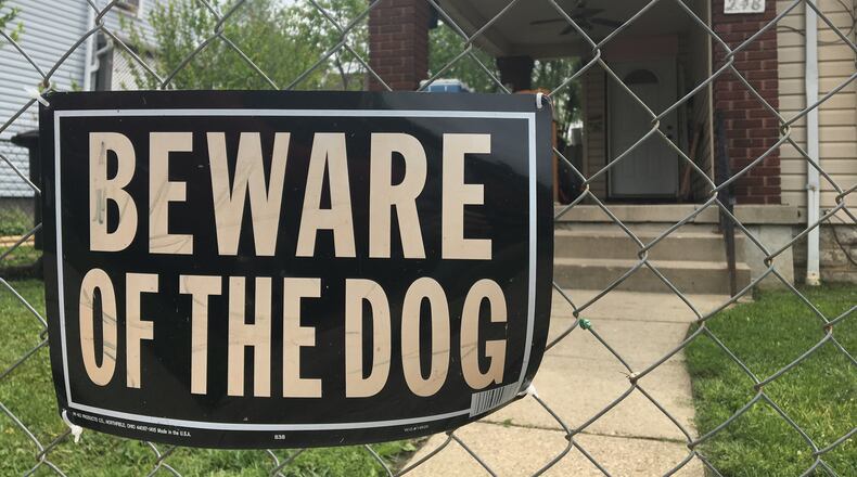 “Beware of dog” signs are posted in yards and on the porches of homes across the region. CORNELIUS FROLIK / STAFF