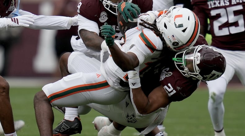 Miami wide receiver Malachi Toney (10) is tackled after a short run by Texas A&M linebacker Taurean York (21) during the first quarter in the first round of the NCAA College Football Playoff, Saturday, Dec. 20, 2025, in College Station, Texas. (AP Photo/Sam Craft)
