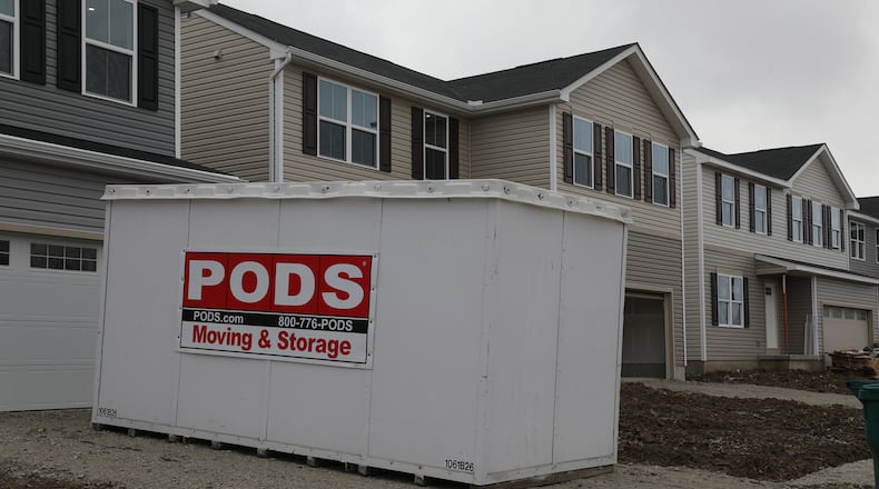 A moving and storage unit in a driveway at a new housing development called Bridgewater that is located on Tuttle Road. The third phase of the development is slated to start this year. BILL LACKEY/STAFF