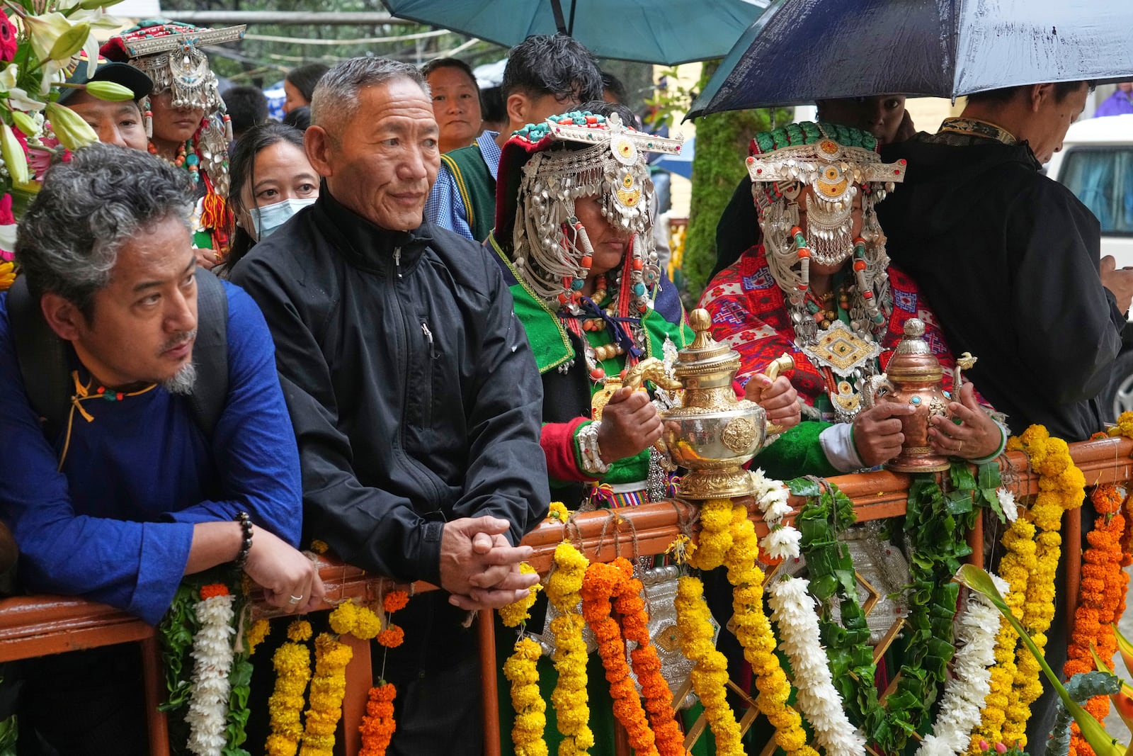 Devotees in their traditional dress wait for the arrival of Tibetan spiritual leader the Dalai Lama to attend an event celebrating his 90th birthday in Dharamshala, India, Sunday, July 6, 2025. (AP Photo/Ashwini Bhatia)