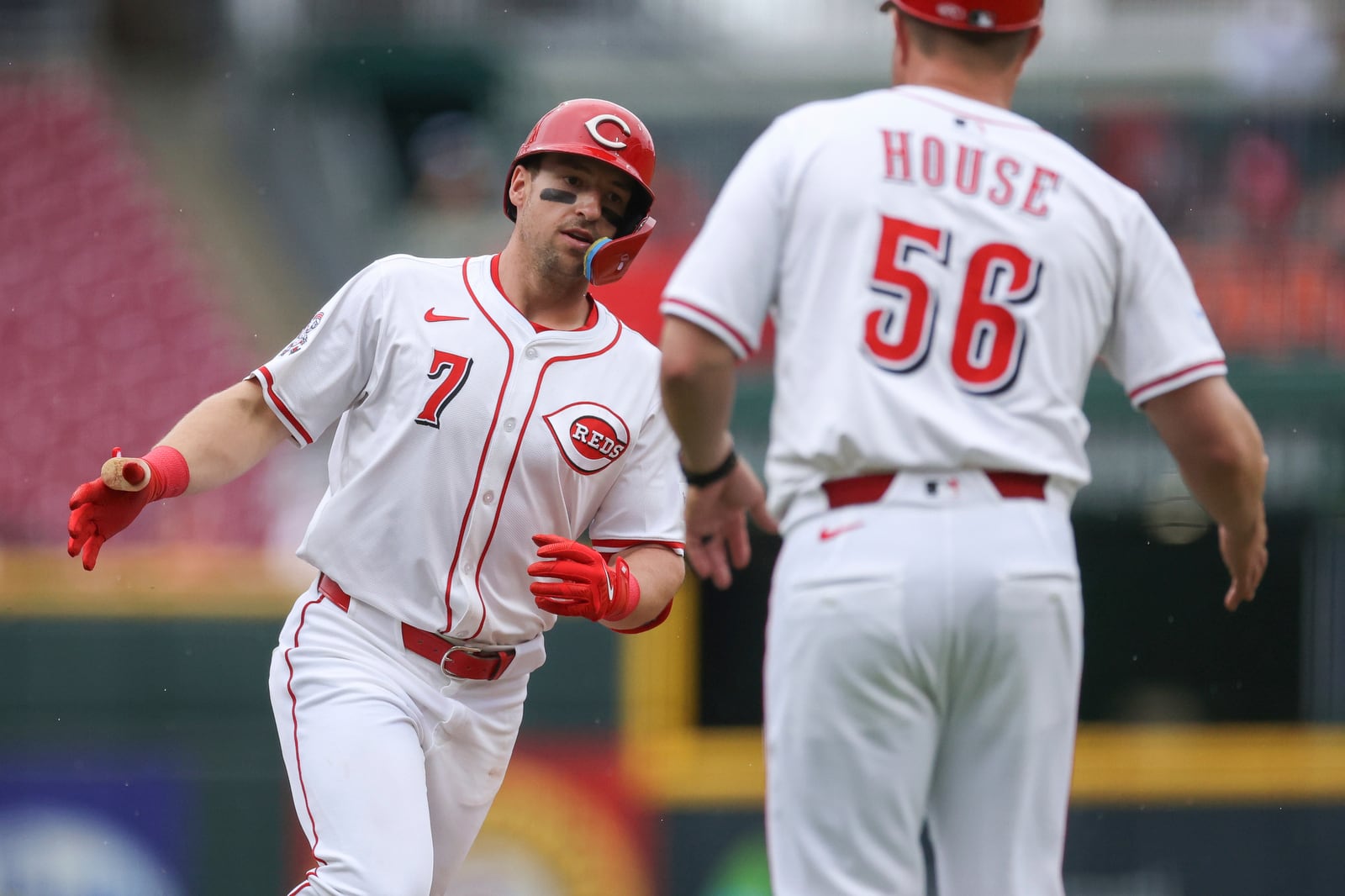 Cincinnati Reds' Spencer Steer (7) celebrates with third base coach J.R. House (56) after hitting a solo home run during the sixth inning of a baseball game against the St. Louis Cardinals, Thursday, May 1, 2025, in Cincinnati. (AP Photo/Abdoul Sow)