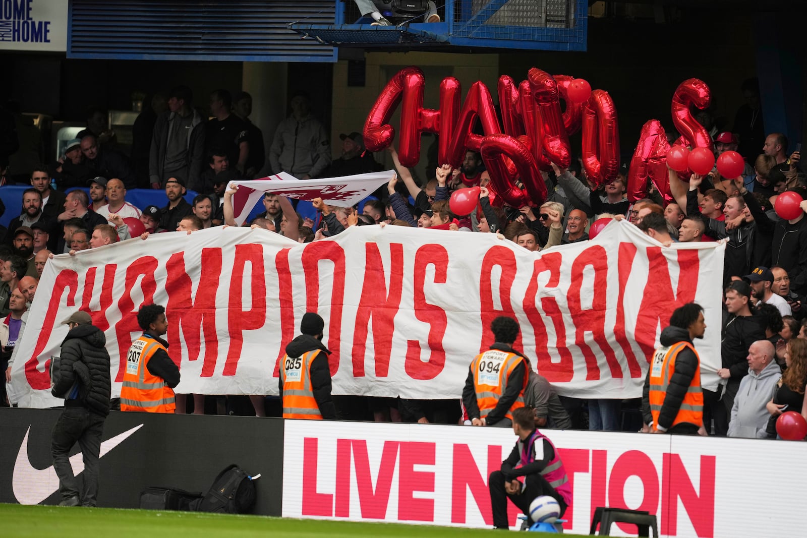 Liverpool fans cheer for their team prior to the English Premier League soccer match between Chelsea and Liverpool at Stamford Bridge stadium in London, Sunday, May 4, 2025. (AP Photo/Kin Cheung)
