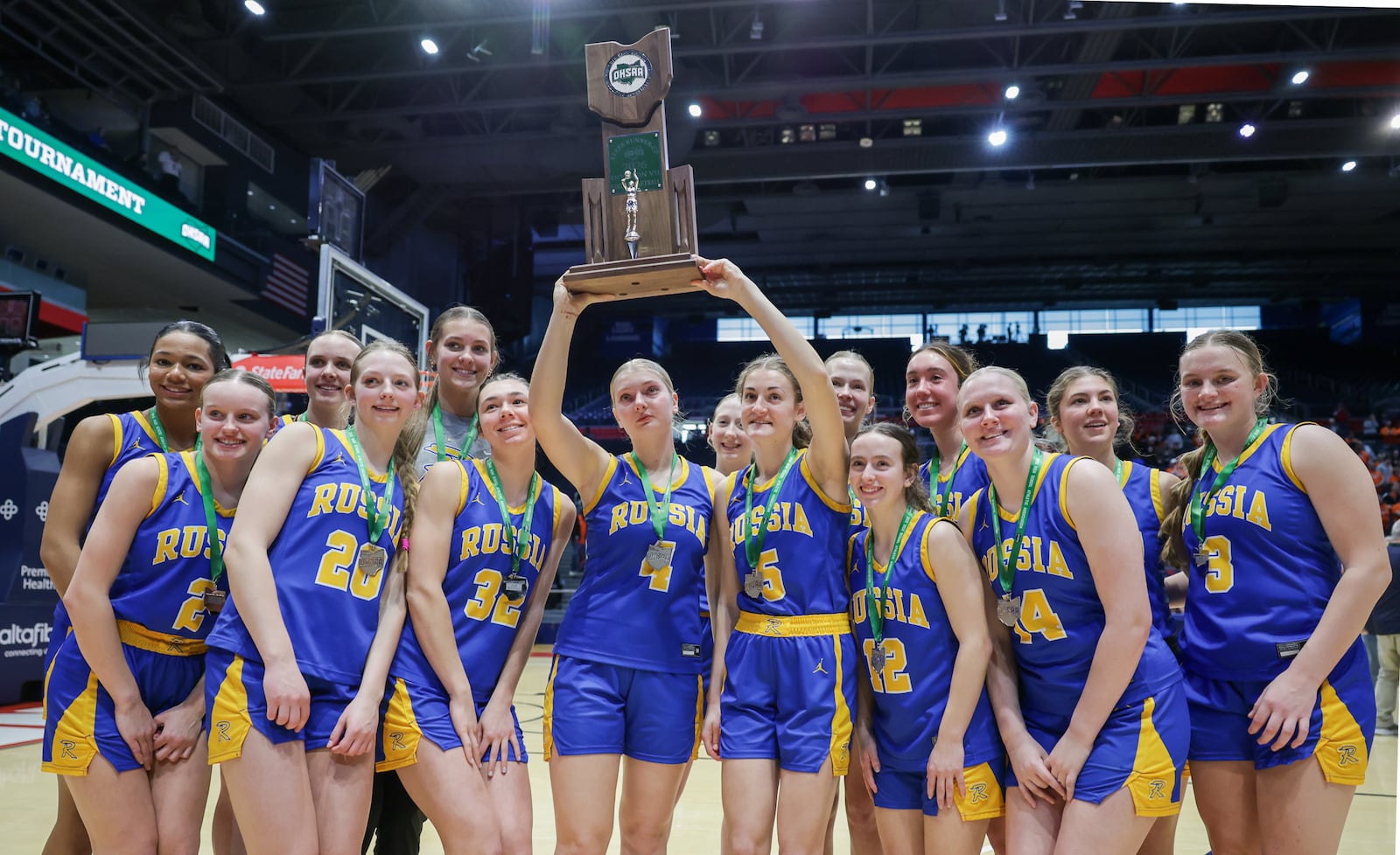 Russia players hoist the Divsion VII state runner-up trophy after falling 38-17 in the Division VI state final on Saturday, March 14 at University of Dayton Arena. BRYANT BILLING / STAFF