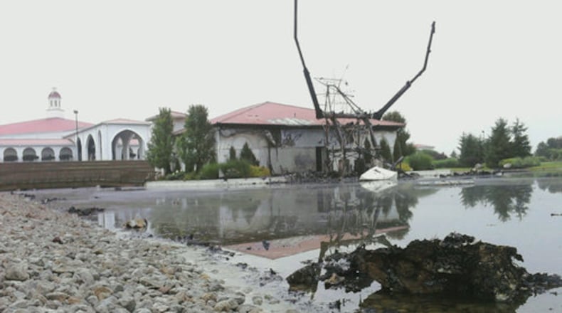 Only the frame remains of the Jesus statue after it was struck by lightning and consumed by fire overnight on Tuesday, June 15, 2010 at the Solid Rock Church in Monroe, Ohio.