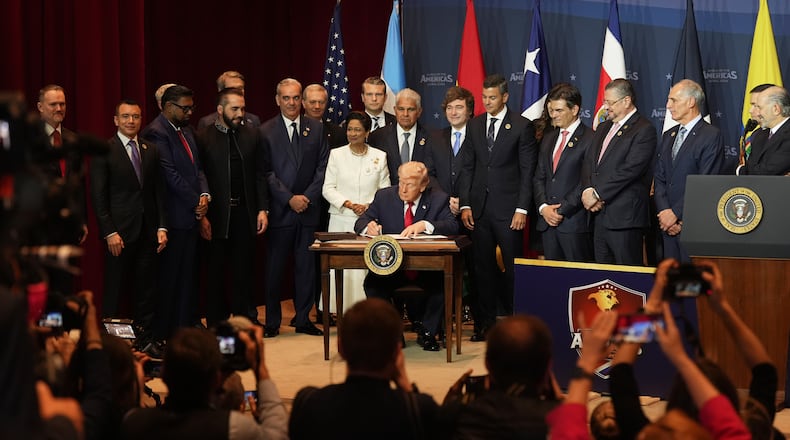 President Donald Trump signs a proclamation committing to countering cartel criminal activity at the Shield of the Americas Summit, Saturday, March 7, 2026, at Trump National Doral Miami in Doral, Fla. (AP Photo/Rebecca Blackwell)