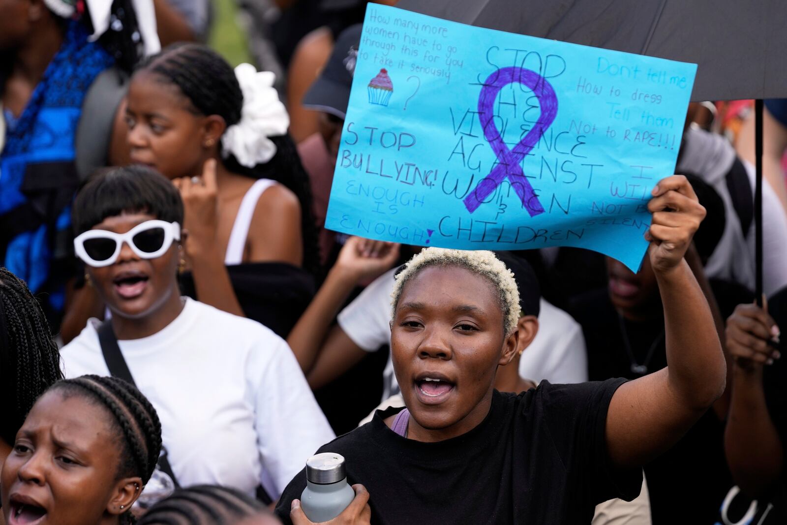 Activists chant slogans as they hold placards during the women's protest and hand over of a petition demanding that gender-based violence and femicide be declared a national disaster, at the Union Buildings in Pretoria, South Africa, Friday, April 11, 2025. (AP Photo/Themba Hadebe)