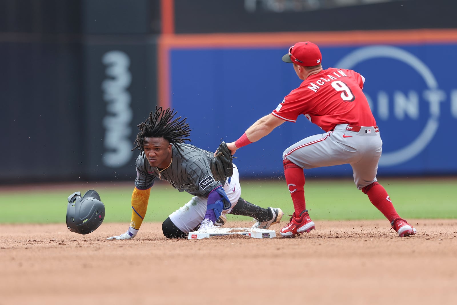 New York Mets' Luisangel Acuña slides safely to second base past Cincinnati Reds second baseman Matt McLain (9) in the fifth inning of a baseball game, Sunday, July 20, 2025, in New York. (AP Photo/Heather Khalifa)
