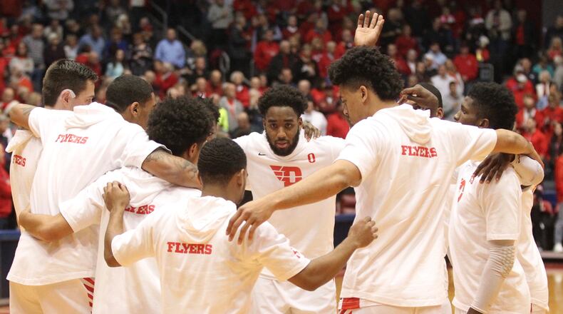 Dayton players, including Josh Cunningham, center, huddle before a game against Western Michigan on Dec. 19, 2018, at UD Arena. David Jablonski/Staff