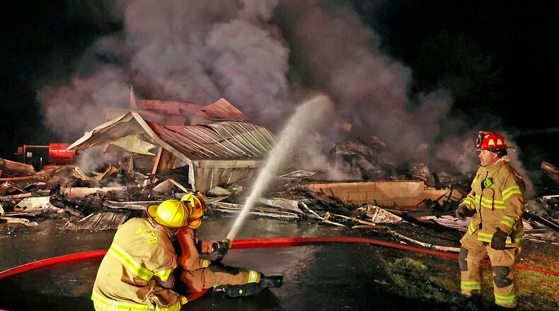 Fire departments from Bethel Twp., New Carlisle, Pike Twp., German Twp., Moorefield Twp., Springfield Twp. and Bethel Twp. in Miami County responded to a barn fire at 1729 Liberty Road Tuesday, July 4, 2023 around 11 P.M. The barn, which was completely destroyed, was fully engulfed when the first fire departments arrived on the scene. The heat from the flames also damaged the nearby residence. BILL LACKEY/STAFF