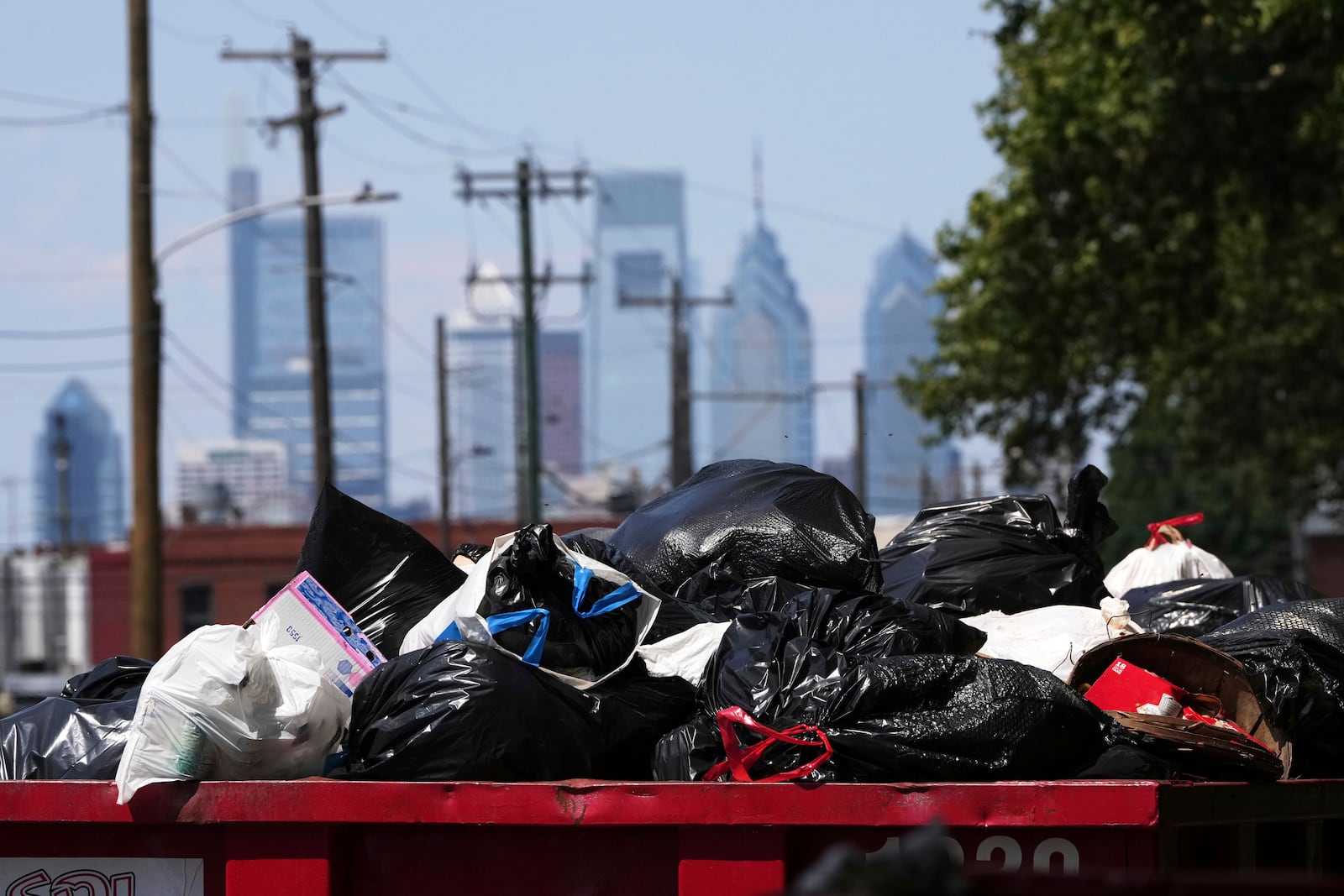 Trash piles up at a garbage collection site, Thursday, July 3, 2025, in Philadelphia. (AP Photo/Matt Slocum)