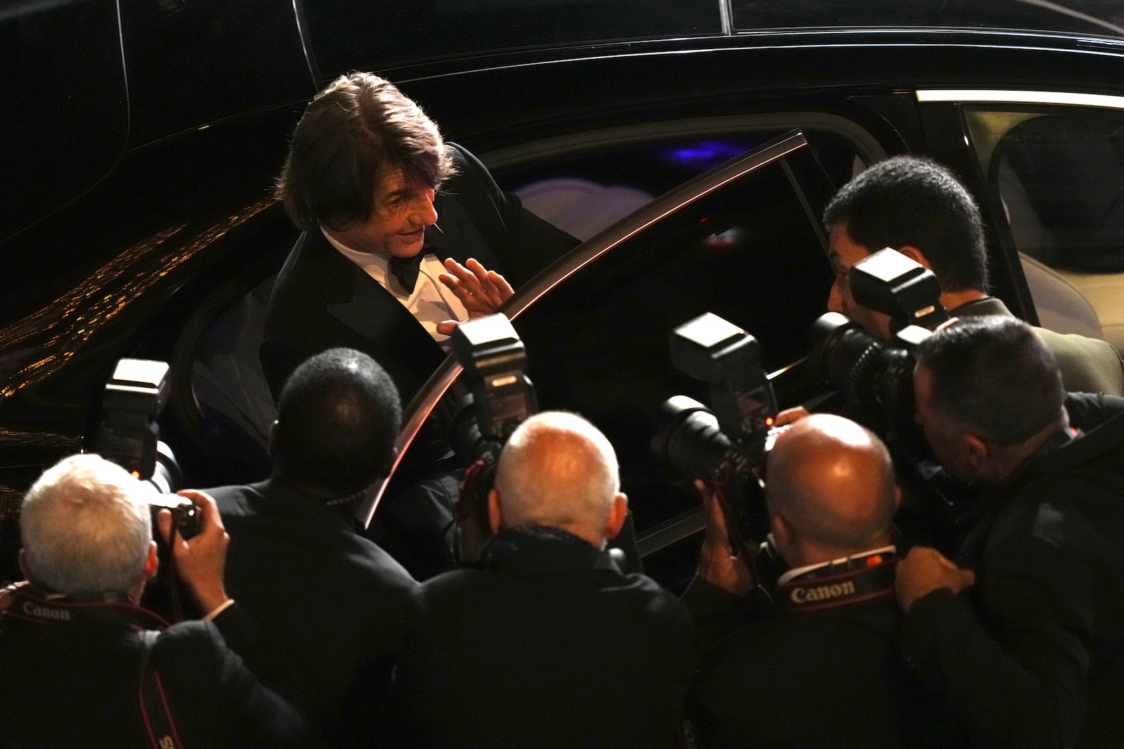 Tom Cruise poses for photographers upon departure from the premiere of the film 'Mission: Impossible – The Final Reckoning' at the 78th international film festival, Cannes, southern France, Wednesday, May 14, 2025. (Photo by Lewis Joly/Invision/AP)