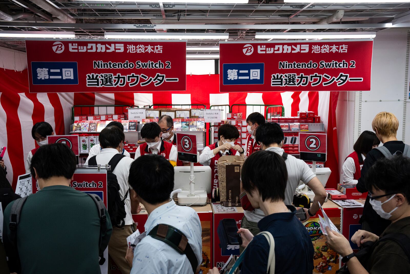 Customers lin up to purchase Nintendo Switch 2 at an electronics retailer in Tokyo, Thursday, June 5, 2025. (AP Photo/Louise Delmotte)