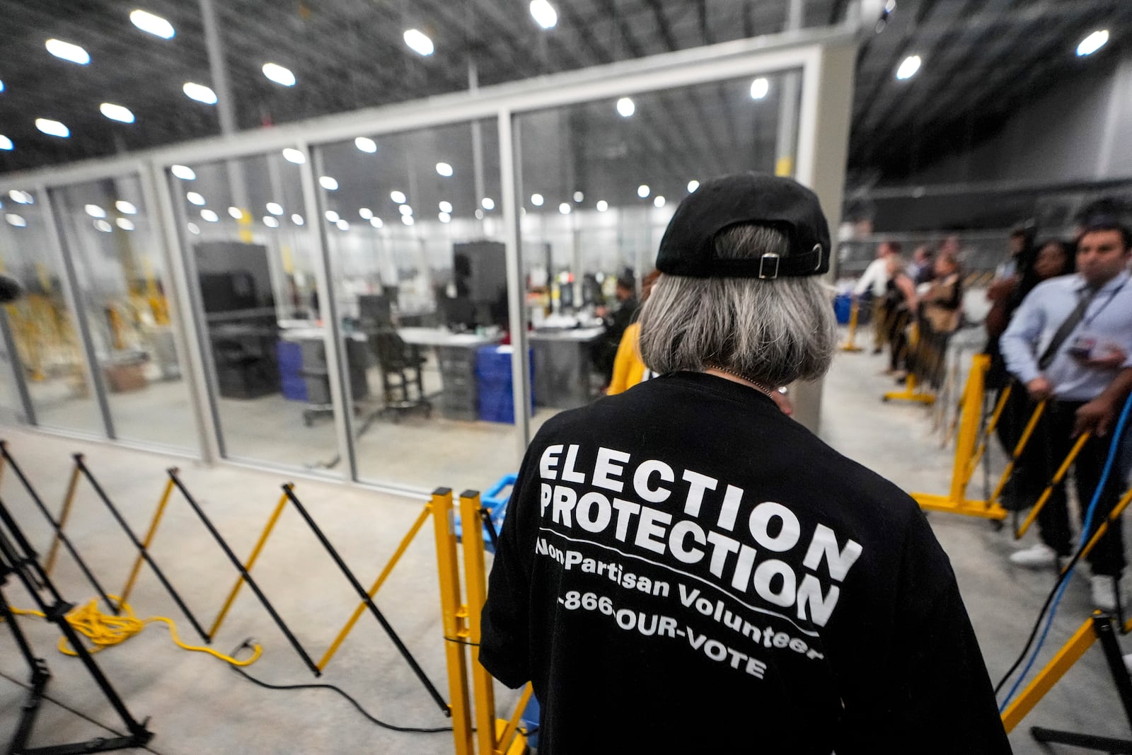 FILE - A non-partisan election volunteer observes as memory cards are uploaded from early voting at the Fulton County Election Hub and Operation Center, Nov. 5, 2024, in Atlanta, Mo. (AP Photo/John Bazemore, File)