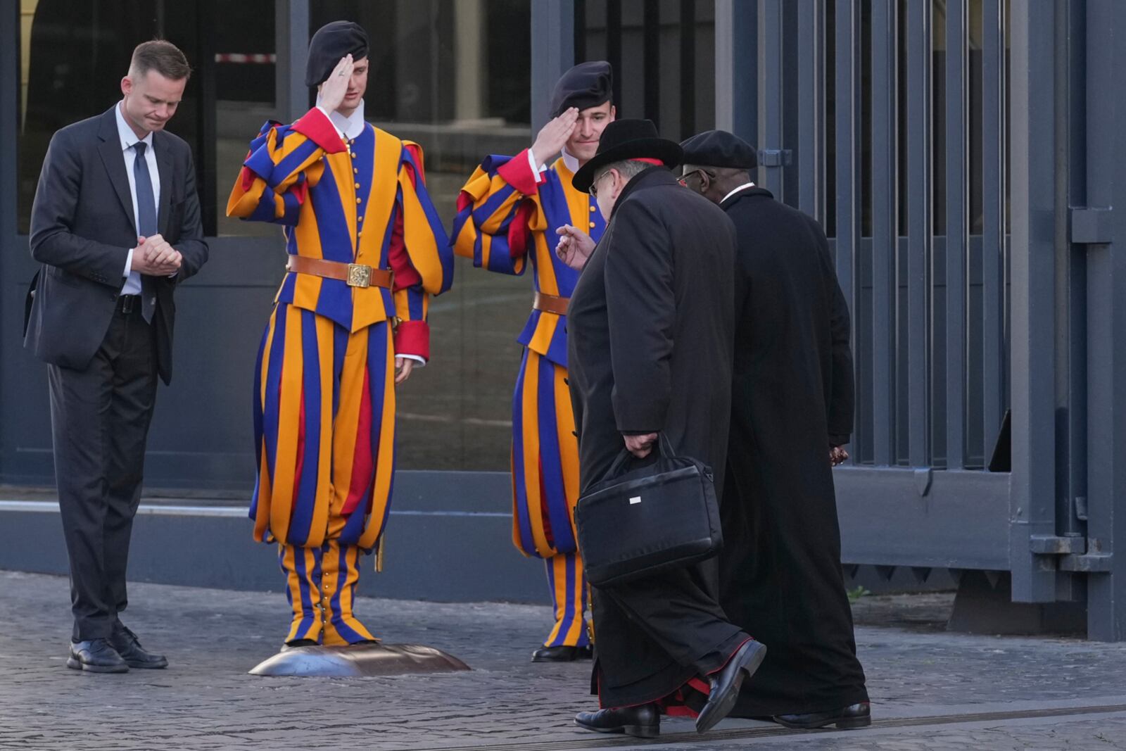 Cardinals, right, arrive for a meeting of cardinals, at the Vatican, Tuesday, April 22, 2025. (AP Photo/Andrew Medichini)