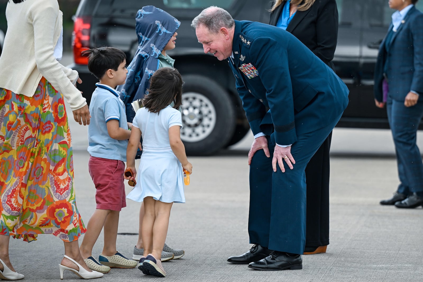 U.S. Air Force General James Hecker leans down to talk with U.S. Vice President JD Vance's children prior to Vance and his family departing Ramstein Air Base, Germany, Thursday April 24, 2025. (Kenny Holston/Pool Photo via AP)