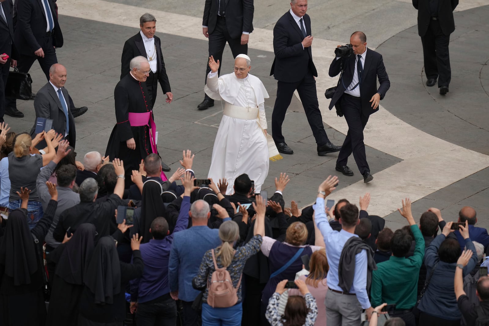 Pope Leo XIV waves at the end of his first weekly general audience in St. Peter's Square at The Vatican, Wednesday, May 21, 2025. (AP Photo/Alessandra Tarantino)
