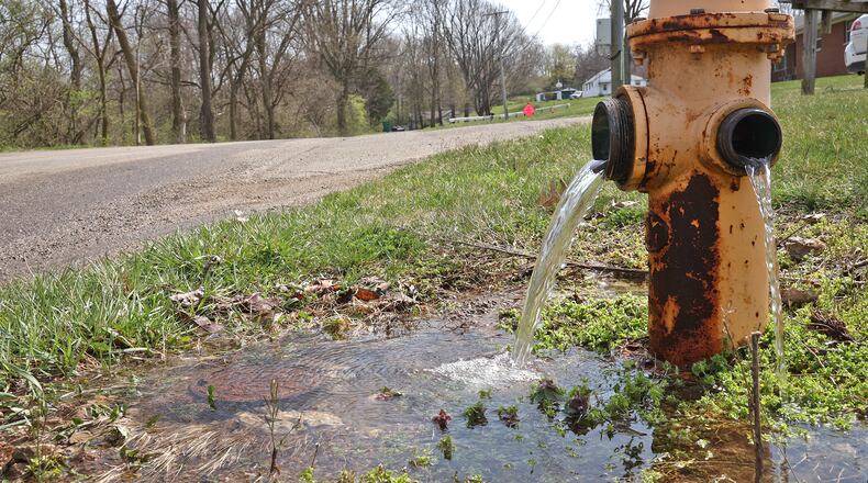 Water pours out of fire hydrants along Ogden Road Wednesday. The Clark County Utilities Department is advising customers in the Holiday Hills and Maplewood water districts to boil their drinking water after water infrastructure repairs, according to a statement from the county. BILL LACKEY/STAFF