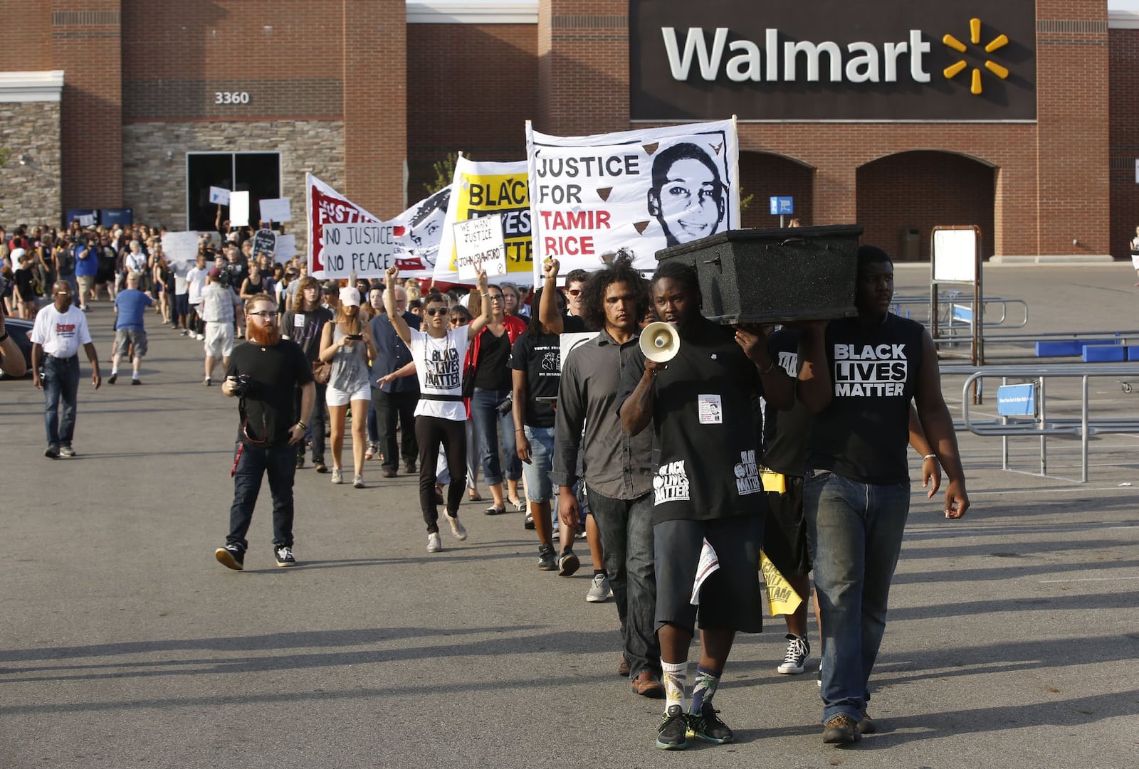 Supporters of John Crawford III held a “Black Lives Matter” rally on the first anniversary of his death by police shooting inside the Beavercreek Walmart in 2014. The rally then performed a die-in at the entrance of the store with a mock coffin. TY GREENLEES / STAFF