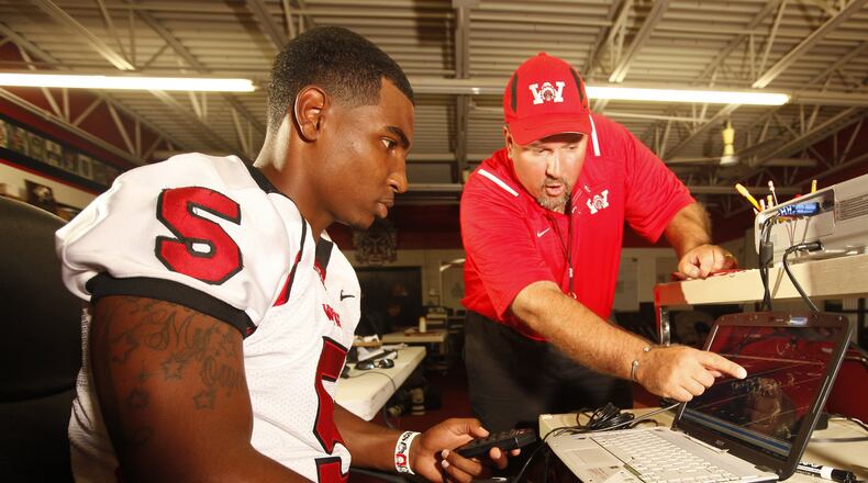 Braxton Miller, the Wayne High School quarterback who has committed to play his college football at Ohio State, is one of the most outrageous athletic talents to come through the area in recent memory. Some services have ranked him the No. 1 overall recruit in the country. He looks at game film with offensive coordinator Brian Blevins, who is on Wayne’s staff for the first year after resigning as Fairmont High School’s head coach. Staff photo by Jim Witmer