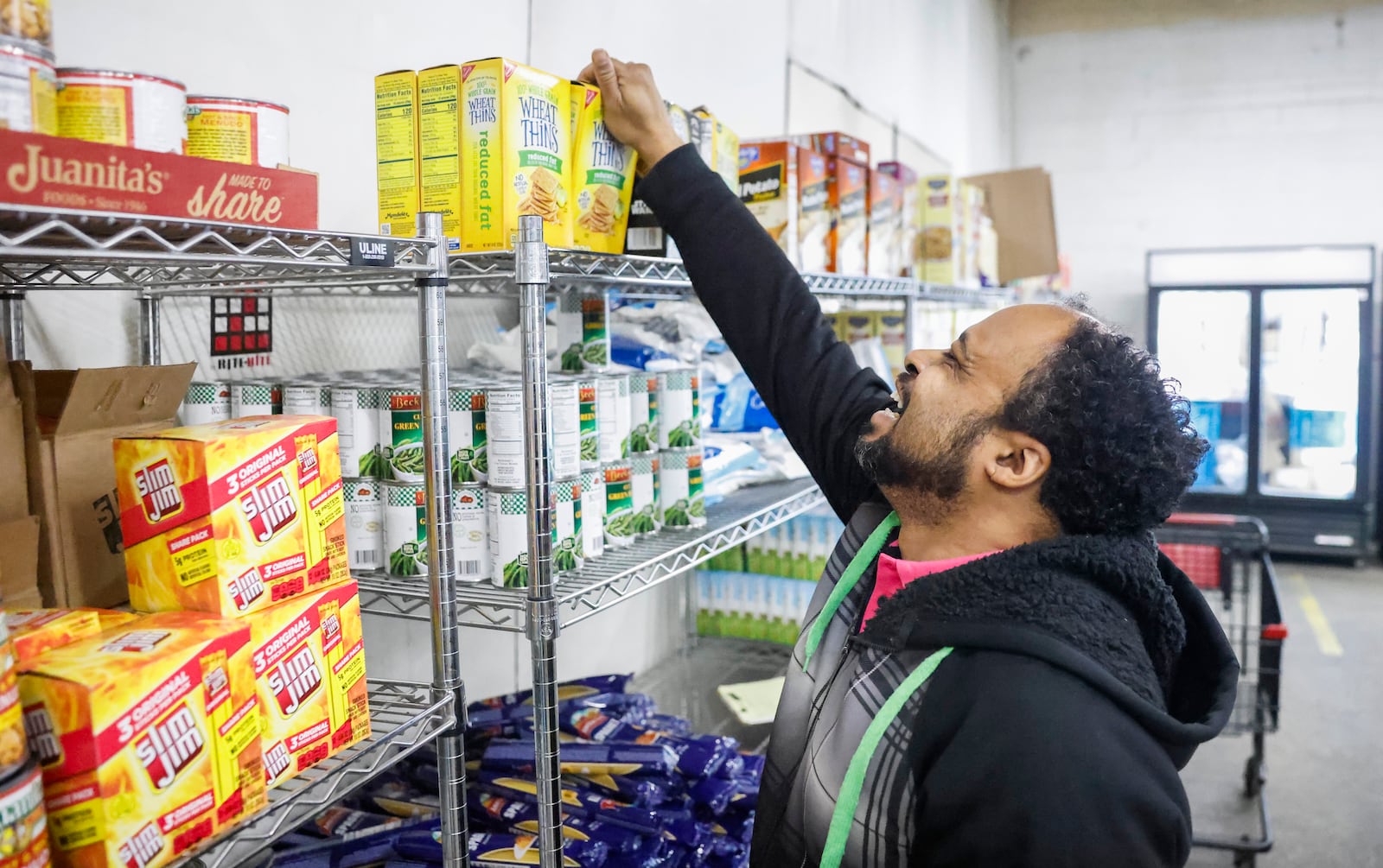 Bruce Dudley stocks Wheat Thins boxes on shelves at Second Harvest Food Bank on Thursday, Nov. 13, 2025, in Springfield. JOSEPH COOKE/STAFF