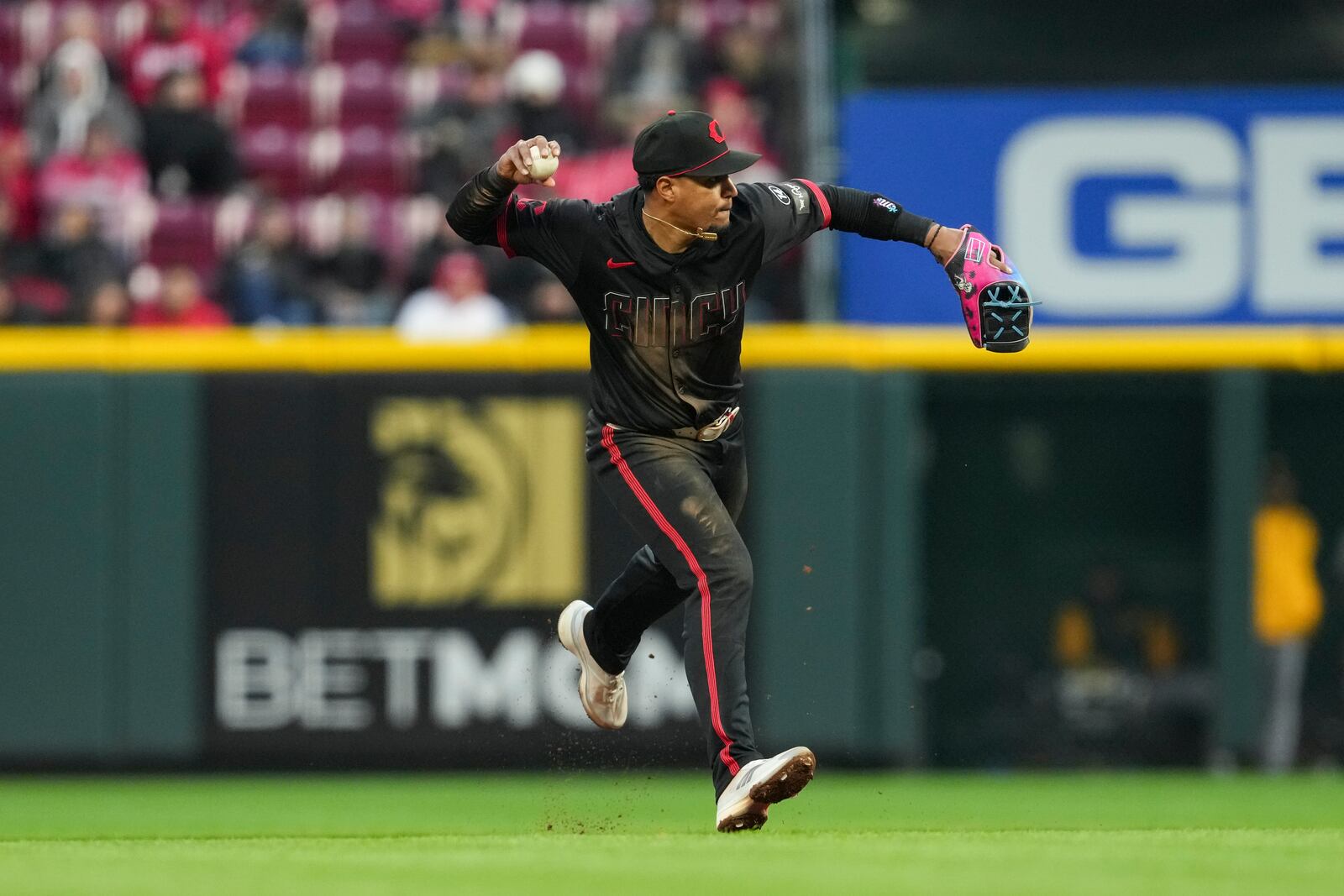 Cincinnati Reds' Santiago Espinal looks to throw out Pittsburgh Pirates' Enmanuel Valdez at first base during the fifth inning of a baseball game, Friday, April 11, 2025, in Cincinnati. (AP Photo/Jeff Dean)