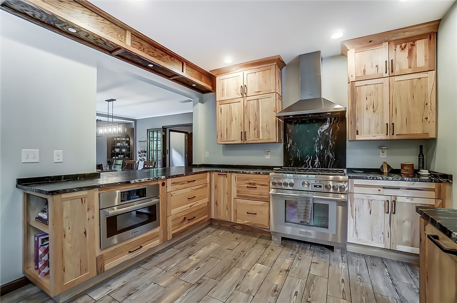 The remodeled and updated kitchen has tile flooring, custom wood cabinets and new professional style appliances. CONTRIBUTED