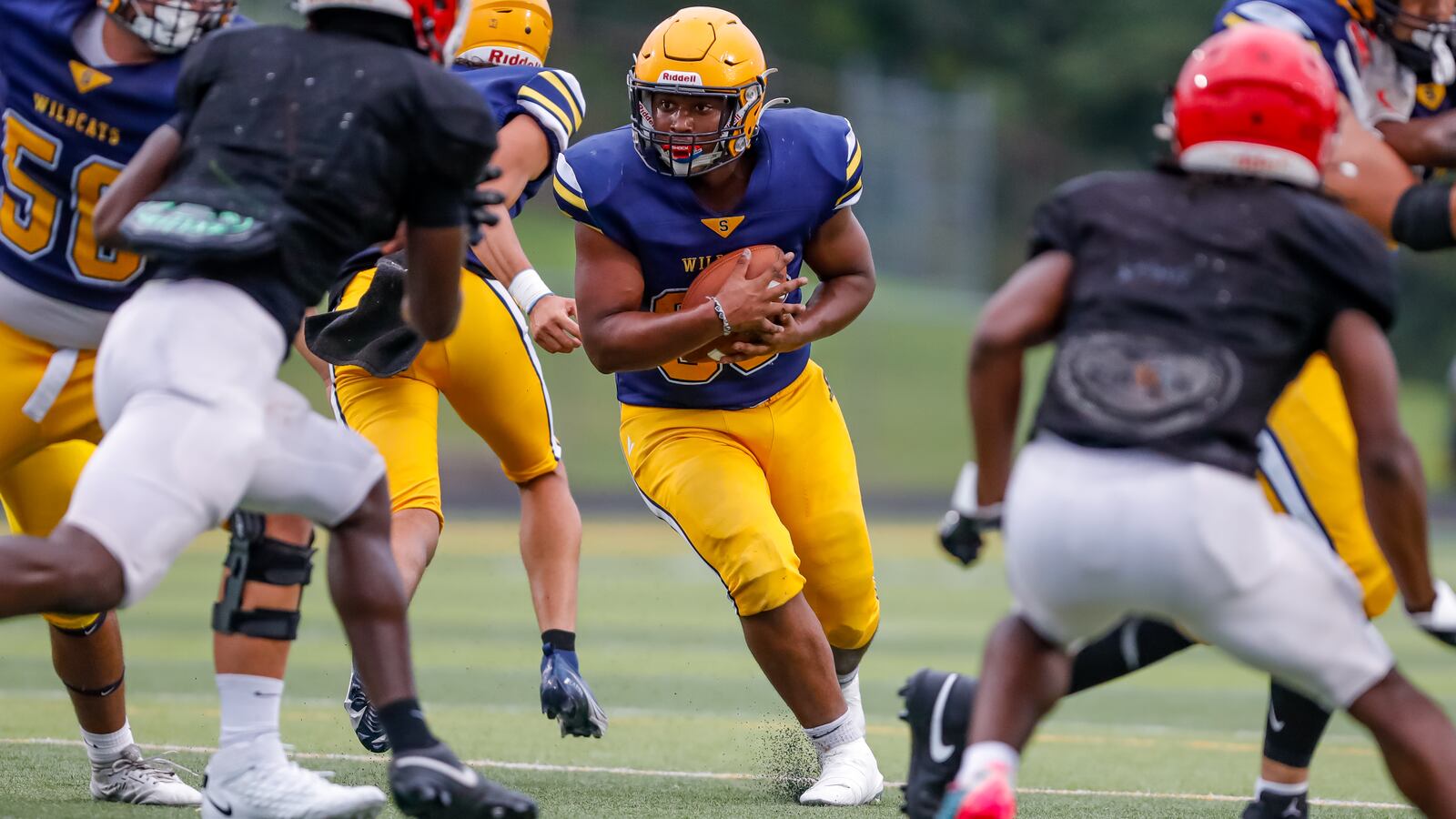 Springfield High School senior Calvin Mitchell runs the ball during a scrimmage against Cincinnati Princeton on Thursday night in Springfield. Michael Cooper/CONTRIBUTED