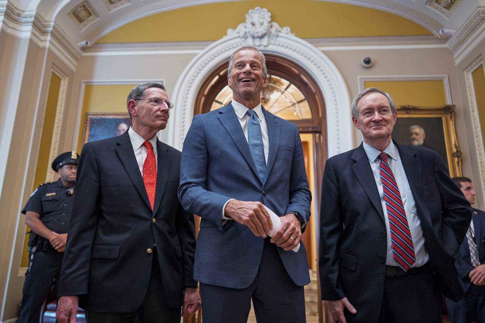 Senate Majority Leader John Thune, R-S.D., is flanked by Sen. John Barrasso, R-Wyo., the GOP whip, left, and Finance Committee Chairman Mike Crapo, R-Idaho, as he speaks to reporters just after passage of the budget reconciliation package of President Donald Trump's signature bill of big tax breaks and spending cuts, at the Capitol in Washington, Tuesday, July 1, 2025. The bill now moves back to the House for final consideration. (AP Photo/J. Scott Applewhite)