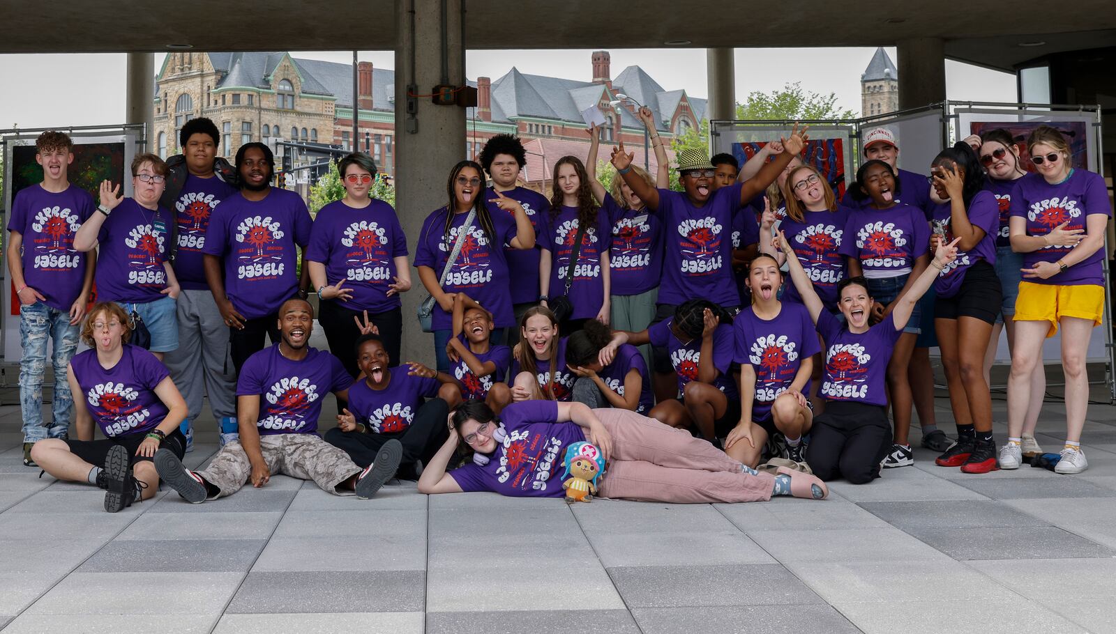 Kids and counselors pose for a portrait during Project Jericho Summer Arts Camp on Friday, June 13, 2025, at Springfield City Plaza. JOSEPH COOKE/STAFF

