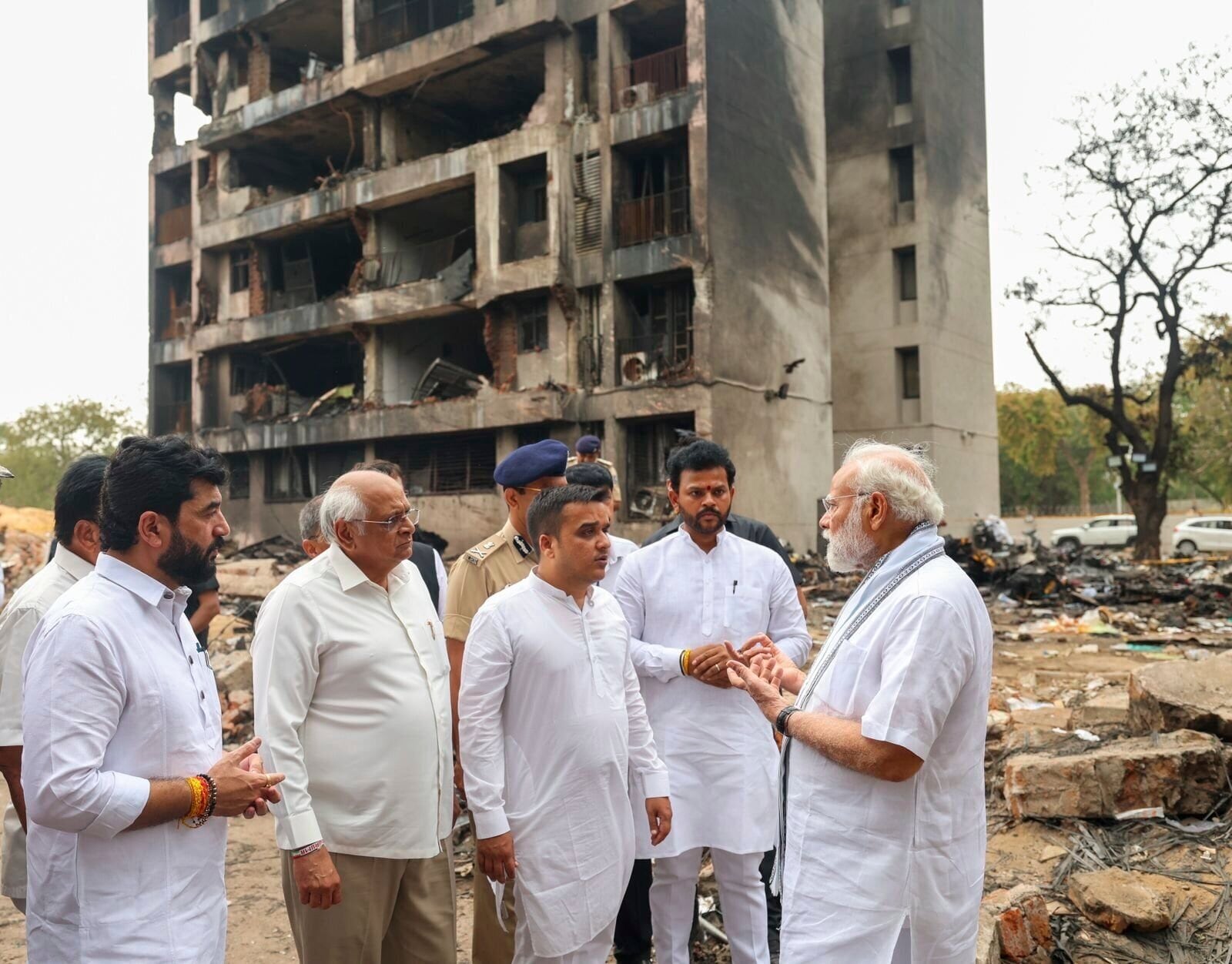 This photo shared by Indian Prime Minister Narendra Modi on X shows him inspecting the site of a plane crash in the northwestern Indian city of Ahmedabad, in Gujarat state, Friday, June 13, 2025. (Prime Minister Narendra Modi on X via AP)