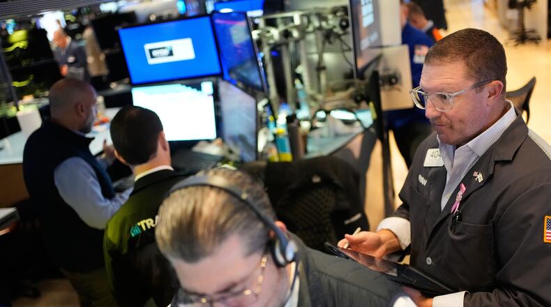 Ryan Falvey, right, works on the floor at the New York Stock Exchange in New York, Wednesday, Oct. 29, 2025. (AP Photo/Seth Wenig)