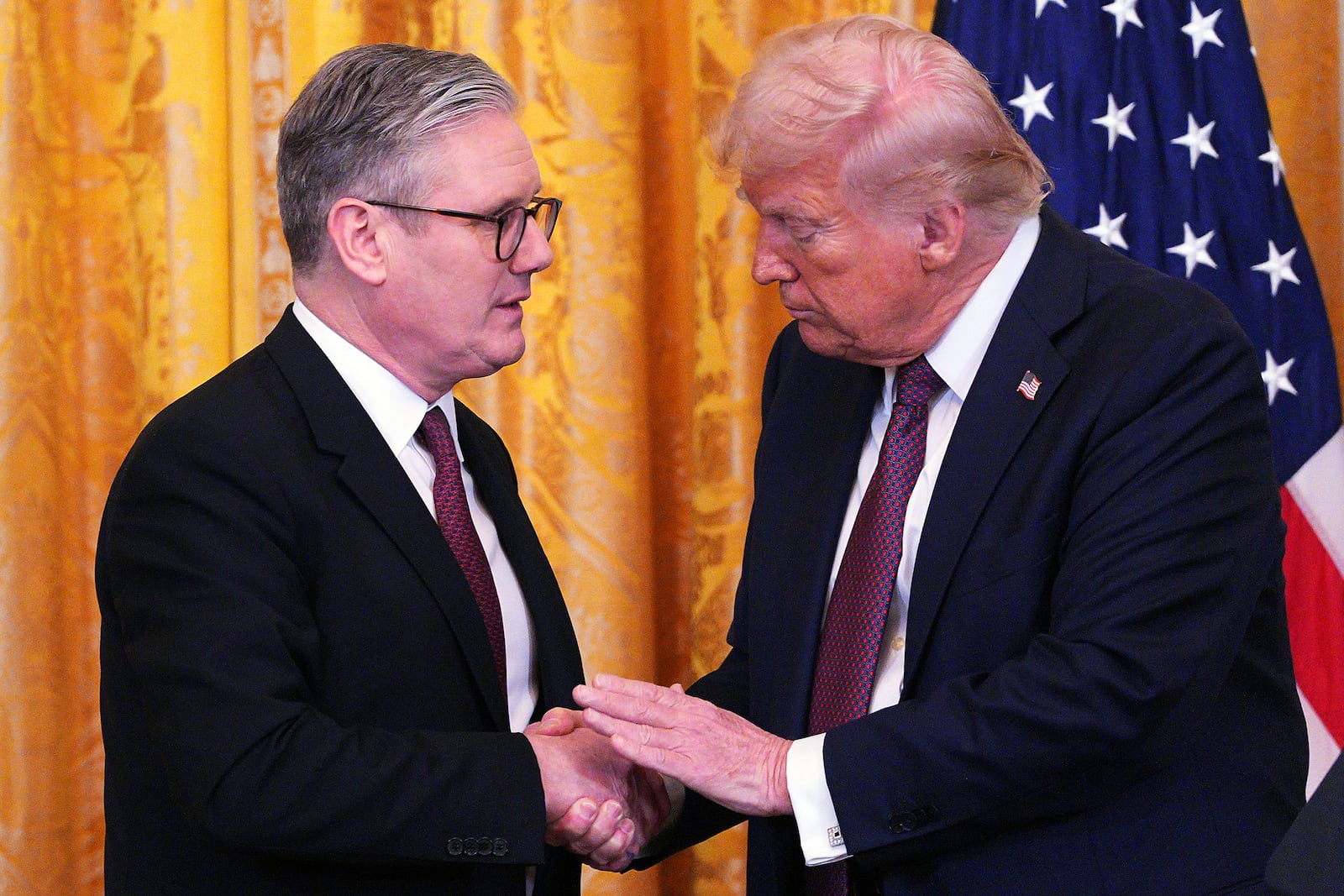 FILE - Britain's Prime Minister Keir Starmer, left, and U.S. President Donald Trump shake hands at a joint press conference in the East Room at the White House Thursday, Feb. 27, 2025, in Washington. (Carl Court/Pool Photo via AP, File)