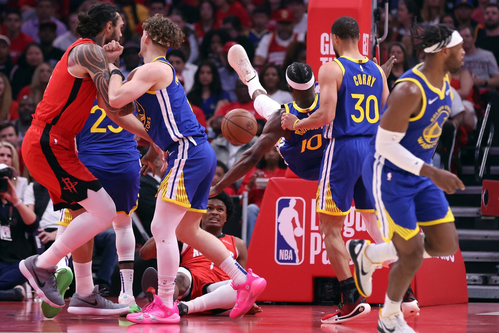 Golden State Warriors' Jimmy Butler III falls towards the court after being fouled by Houston Rockets' Amen Thompson in 1st quarter of Game 2 of First Round of NBA Playoffs in Houston, Texas on Wednesday, April 23, 2025. (Scott Strazzante/San Francisco Chronicle via AP)
