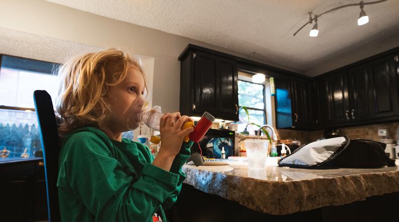 File - Lachlan Rutledge, 6, during his morning routine which involves time with the inhaler after breakfast while preparing for school, in Broken Arrow, Okla. on Oct. 3, 2022. Liquid albuterol for nebulizers continues to be in short supply in March 2023, but a spacer device can be used with an inhaler that is just as effective as a nebulizer, doctors say. (Melissa Lukenbaugh/The New York Times)