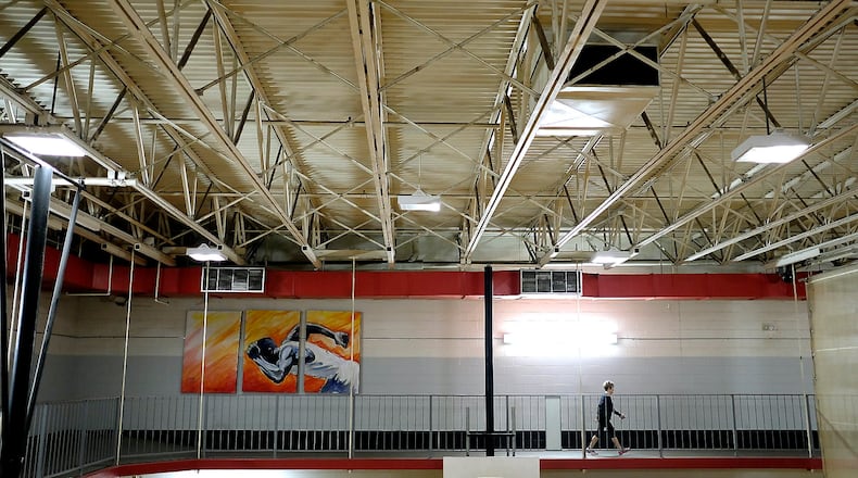 A guest walks on the second floor walking track around the Springfield YMCA gymnasium. BILL LACKEY/STAFF