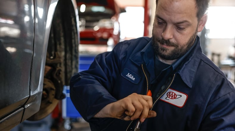 AAA auto mechanic Michael Mollett replaces brakes at the service center in Beavercreek Thursday, March 28, 2024. Auto repair is a good industry for workers to be in right now, said Dan Scroggins, vice president of personal lines insurance at AAA. Wages are up significantly over the last three years, and there is a ton of work, Scroggins said.  JIM NOELKER/STAFF