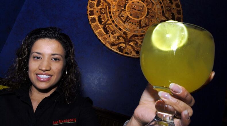 The staff at Los Mariachis Mexican restaurant are ready to serve food and spirits for Cinco de Mayo at home. BILL LACKEY/STAFF