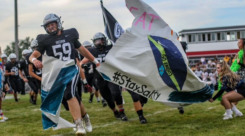 Greenon players take the field before Friday night’s season opener vs. Shawnee. Michael Cooper/CONTRIBUTED