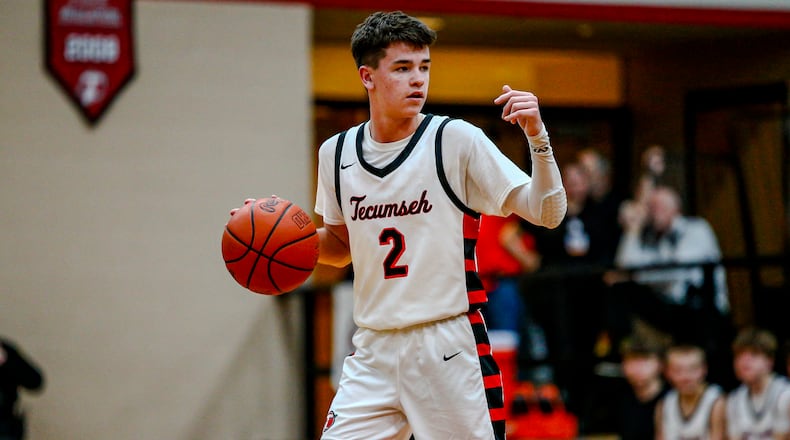 Tecumseh High School junior Chase Stafford dribbles the ball during their game against Kenton Ridge on Friday night in New Carlisle. Stafford had a game-high 28 points, but the Cougars won 74-68. Christian Cooper/CONTRIBUTED