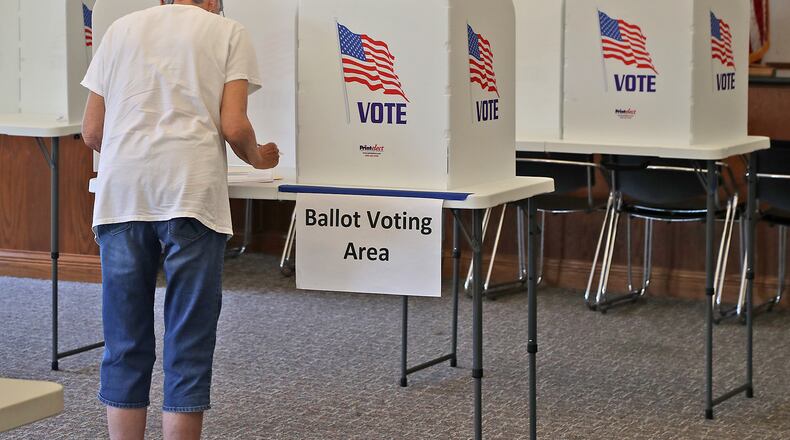 Voters cast their ballot at the election poll in the Springfield Township Government Center Tuesday, July 2, 2022. BILL LACKEY/STAFF